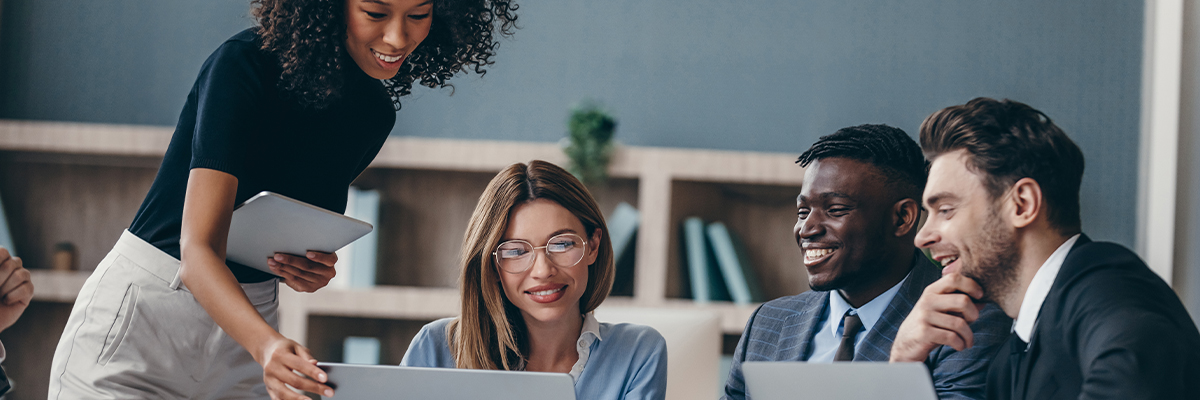 Group of colleagues smiling while collaborating
