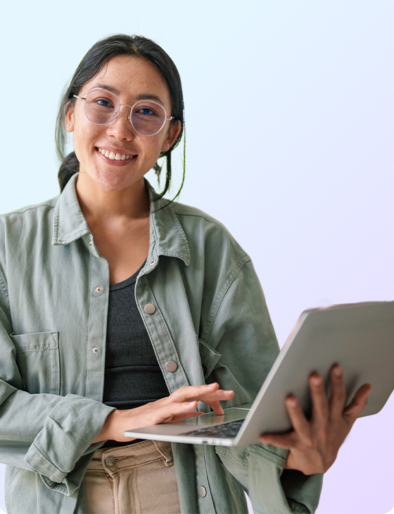 woman smiling while working on a laptop